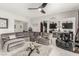 Comfortable living room with a large sectional sofa, modern decor, and an open view to the kitchen at 5616 Silver Cascade Ave, Las Vegas, NV 89131