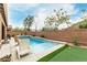 Backyard pool area featuring a modern pool, patio furniture, and green turf at 5616 Silver Cascade Ave, Las Vegas, NV 89131