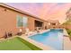 Inviting backyard pool area with well-kept turf and a seating space perfect for outdoor enjoyment at 5616 Silver Cascade Ave, Las Vegas, NV 89131