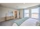 Cozy bedroom featuring a comfortable bed and large windows overlooking the landscape at 6188 Hibiscus Garden St # 174, North Las Vegas, NV 89081