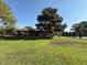 Beautiful home exterior with mature trees and landscaping, providing a serene setting at 6521 Sugarpine Ln, Las Vegas, NV 89107
