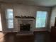 Charming living room with a cozy fireplace decorated for the holidays and well-lit by many windows at 6521 Sugarpine Ln, Las Vegas, NV 89107