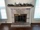 Cozy living room featuring fireplace with decorative mantle and brick surround at 6521 Sugarpine Ln, Las Vegas, NV 89107