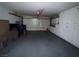 Spacious garage features a roll-up door and built-in white cabinets for ample storage at 6521 Sugarpine Ln, Las Vegas, NV 89107