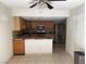 Functional kitchen featuring tile floors, wooden cabinets, granite countertops, and modern stainless steel appliances at 6521 Sugarpine Ln, Las Vegas, NV 89107