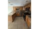 Well-lit kitchen with granite countertops, updated appliances, and tile flooring at 6521 Sugarpine Ln, Las Vegas, NV 89107