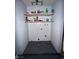 Small laundry room features shelving for storage and connections for a washer and dryer at 6521 Sugarpine Ln, Las Vegas, NV 89107