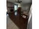 Spacious living room with a brick fireplace, wood floors, and many windows for natural light at 6521 Sugarpine Ln, Las Vegas, NV 89107