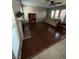 Inviting living room features dark wood floors, many windows, and a brick fireplace at 6521 Sugarpine Ln, Las Vegas, NV 89107