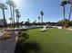 Community pool with lounge chairs and palm trees, ideal for summer relaxation at 6521 Sugarpine Ln, Las Vegas, NV 89107