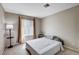 This carpeted bedroom has a bedside table and window with blinds at 7200 Pirates Cove Rd # 2084, Las Vegas, NV 89145