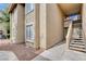 Beige stucco two-story home with a stairs to the entryway at 7200 Pirates Cove Rd # 2084, Las Vegas, NV 89145