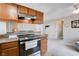 Kitchen with stainless steel appliances and light wood cabinets with an open layout at 7200 Pirates Cove Rd # 2084, Las Vegas, NV 89145