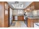 Kitchen with stainless steel appliances, light wood cabinets, and granite countertops at 7200 Pirates Cove Rd # 2084, Las Vegas, NV 89145