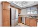 Kitchen with stainless steel refrigerator, dishwasher, sink, and light wood cabinets at 7200 Pirates Cove Rd # 2084, Las Vegas, NV 89145