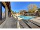 Community pool area with clean blue water, metal fence, and mature trees at 7200 Pirates Cove Rd # 2084, Las Vegas, NV 89145