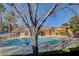 Community pool surrounded by a metal fence, lush trees, and manicured landscaping at 7200 Pirates Cove Rd # 2084, Las Vegas, NV 89145