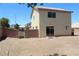 View of the backyard and exterior of the house featuring brick walls and sliding glass doors at 730 Goshawk St, Henderson, NV 89015