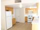 A well lit kitchen area featuring tile flooring and light colored wood cabinets at 730 Goshawk St, Henderson, NV 89015