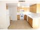 A well lit kitchen area featuring tile flooring and light colored wood cabinets at 730 Goshawk St, Henderson, NV 89015