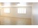 A well lit living room area featuring tile flooring and shuttered windows at 730 Goshawk St, Henderson, NV 89015