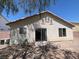 A charming single-story house with a stucco exterior and a sliding door leading to the backyard at 732 Goshawk St, Henderson, NV 89015