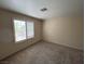 Neutral bedroom showcasing plush carpeting and a sunlit window for a cozy living space at 732 Goshawk St, Henderson, NV 89015