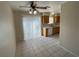 Cozy dining area and view of kitchen with tile floor, ceiling fan, and sliding glass doors to the backyard at 732 Goshawk St, Henderson, NV 89015