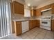 View of kitchen featuring light wood cabinets and white appliances at 732 Goshawk St, Henderson, NV 89015