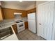 View of kitchen featuring light wood cabinets and white appliances at 732 Goshawk St, Henderson, NV 89015