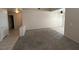 Open-concept living room boasts neutral tones, carpeted floors, and a seamless transition to a tiled dining area and kitchen at 732 Goshawk St, Henderson, NV 89015