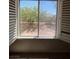 View from window shows desert landscaped yard with mature trees and house in background at 732 Goshawk St, Henderson, NV 89015