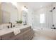 Modern bathroom featuring double sinks, elegant mirrors, and a beautifully tiled shower and tub at 8140 Bay Harbor Dr, Las Vegas, NV 89128