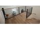 Open-concept foyer with wood staircase and modern railing, overlooking the dining area, creating a grand entrance at 8140 Bay Harbor Dr, Las Vegas, NV 89128