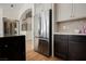 Bright kitchen featuring a stainless steel refrigerator, two-tone cabinets, and white marble countertops at 8140 Bay Harbor Dr, Las Vegas, NV 89128