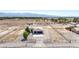 Aerial view shows the single story home with a large lot, gravel landscaping, and mountain views at 861 S Ford Loop, Pahrump, NV 89048