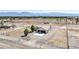 Aerial view of a charming single-story home boasting a two-car garage and well-maintained landscaping at 861 S Ford Loop, Pahrump, NV 89048