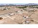 High aerial view of the desert landscape displays available land, buildings, and mountain range scenery at 861 S Ford Loop, Pahrump, NV 89048