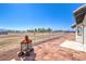 Large backyard with a brick patio, fire pit, and vast land at 861 S Ford Loop, Pahrump, NV 89048