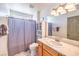 Well-lit bathroom with vanity, mirror, and shower-tub combo at 861 S Ford Loop, Pahrump, NV 89048