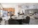 Open-concept dining area with modern table set adjacent to a well-equipped kitchen and bright living room at 861 S Ford Loop, Pahrump, NV 89048