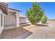 Covered patio area and gravel landscaping with mature landscaping around this single Gathering home at 861 S Ford Loop, Pahrump, NV 89048
