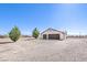 Detached three car garage with gravel landscaping and mature landscaping in the front at 861 S Ford Loop, Pahrump, NV 89048