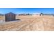 The large backyard includes a storage shed, open space, and a view of the home's rear exterior at 861 S Ford Loop, Pahrump, NV 89048