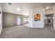 Open living room with neutral carpet and paint, with a pass-through to the adjacent eat-in kitchen at 861 S Ford Loop, Pahrump, NV 89048
