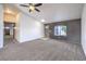 Large, open living room with neutral carpet, light gray accent wall, and a ceiling fan at 861 S Ford Loop, Pahrump, NV 89048