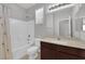 Bathroom featuring a shower-tub combo and a neutral-toned vanity with a large mirror at 9467 Samuel Clemens Ct, Las Vegas, NV 89147