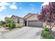 Charming single-story home features a well-maintained front yard and a two-car garage at 9467 Samuel Clemens Ct, Las Vegas, NV 89147