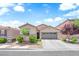Charming single-story home features a well-maintained front yard and a two-car garage at 9467 Samuel Clemens Ct, Las Vegas, NV 89147