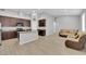 Spacious open concept kitchen with stainless appliances and granite counters flows into the living room at 9467 Samuel Clemens Ct, Las Vegas, NV 89147